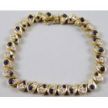 A sapphire and diamond bracelet, with abstract graduated stones, yellow metal, unmarked, possibly