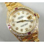 An 18ct gold Rolex Oyster Perpetual ladies wristwatch, with ruby and diamond surround, with
