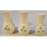 A pair of 20thC Belleek vases, the shouldered bodies with shamrock decoration, 12cm high, and a