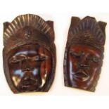 Two 20thC African hardwood tribal masks, the first wearing elaborate headdress with part pierced