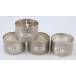 A set of four silver napkin rings, by H Bros, each circular body part engine turned and initialled