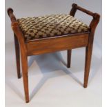 A late Victorian stain mahogany piano stool, with ring turn cylindrical handles and an overstuffed