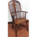 A good 19thC yew wood and elm high back Windsor chair, probably Worksop, with a Christmas tree style