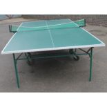 A modern folding table tennis table, by Kettler Germany, on a truckle folding metal base in green