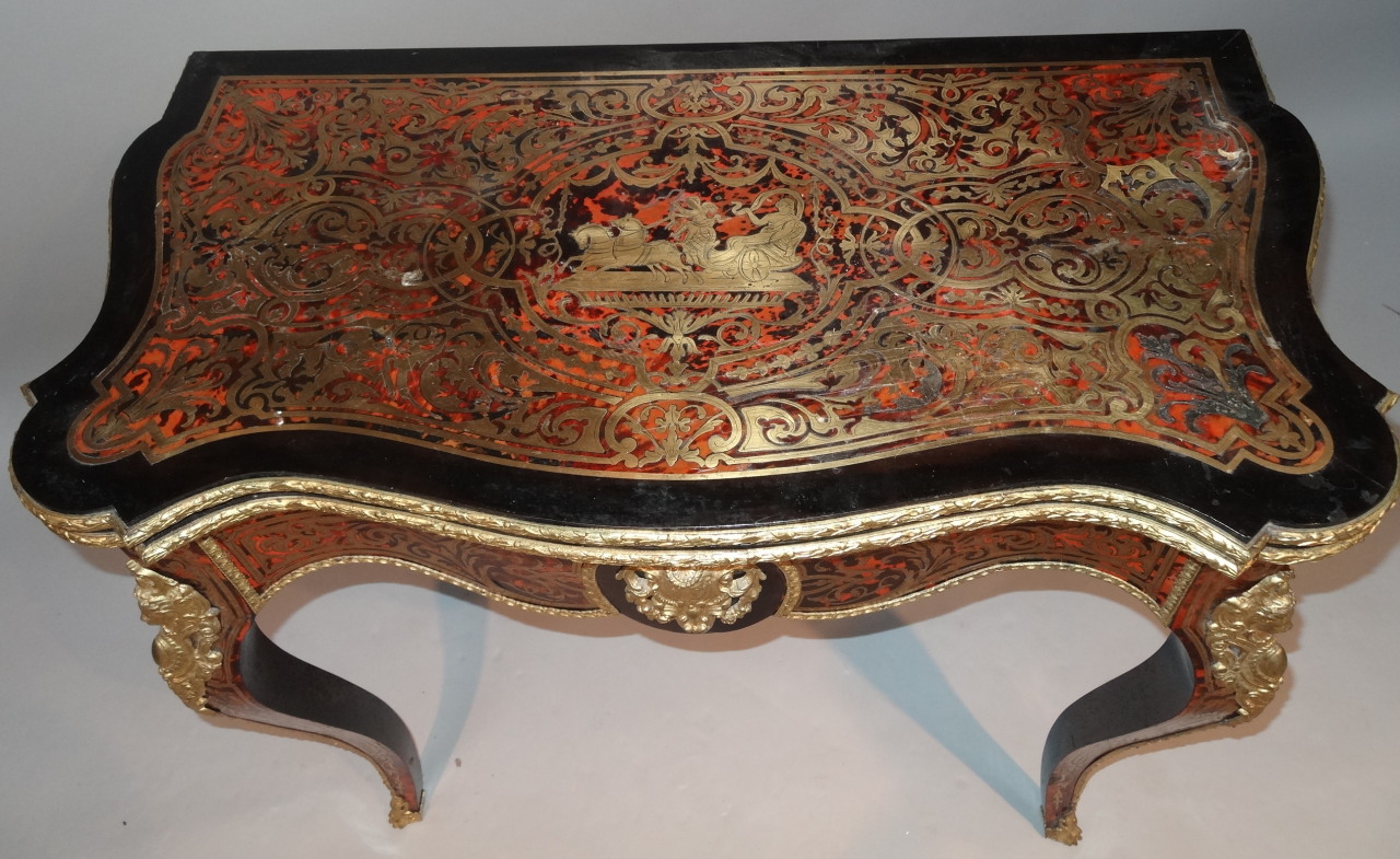 A 19thC French Boulle ebonised and ormolu games table, with serpentine outline the top fronted by - Image 2 of 5