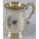 A George II silver baluster tankard, with scroll handle, London 1735, 10cm high, 8oz.