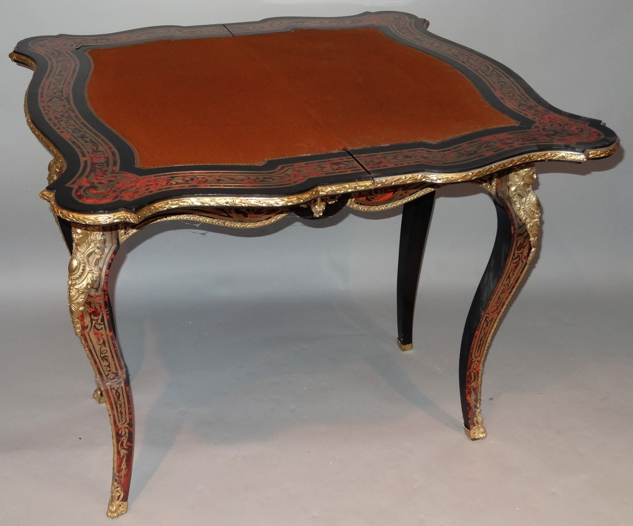 A 19thC French Boulle ebonised and ormolu games table, with serpentine outline the top fronted by - Image 4 of 5