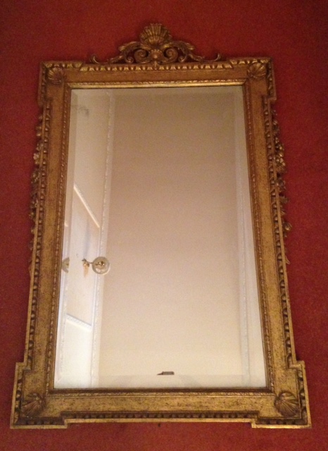 A pair of 19thC giltwood and gesso wall mirrors, in the manner of William Kent, with shell and