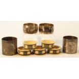 Various Chinese napkin rings, to include a pair of metal examples repoussé decorated, 5cm high,