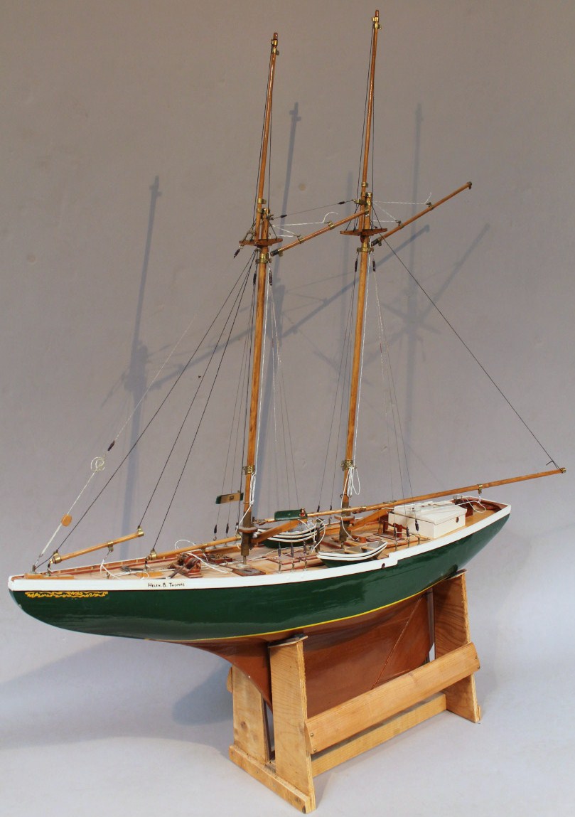 A 20thC wooden model yacht, of the Helen B Thomas, with authentic rigging mast and deck set with