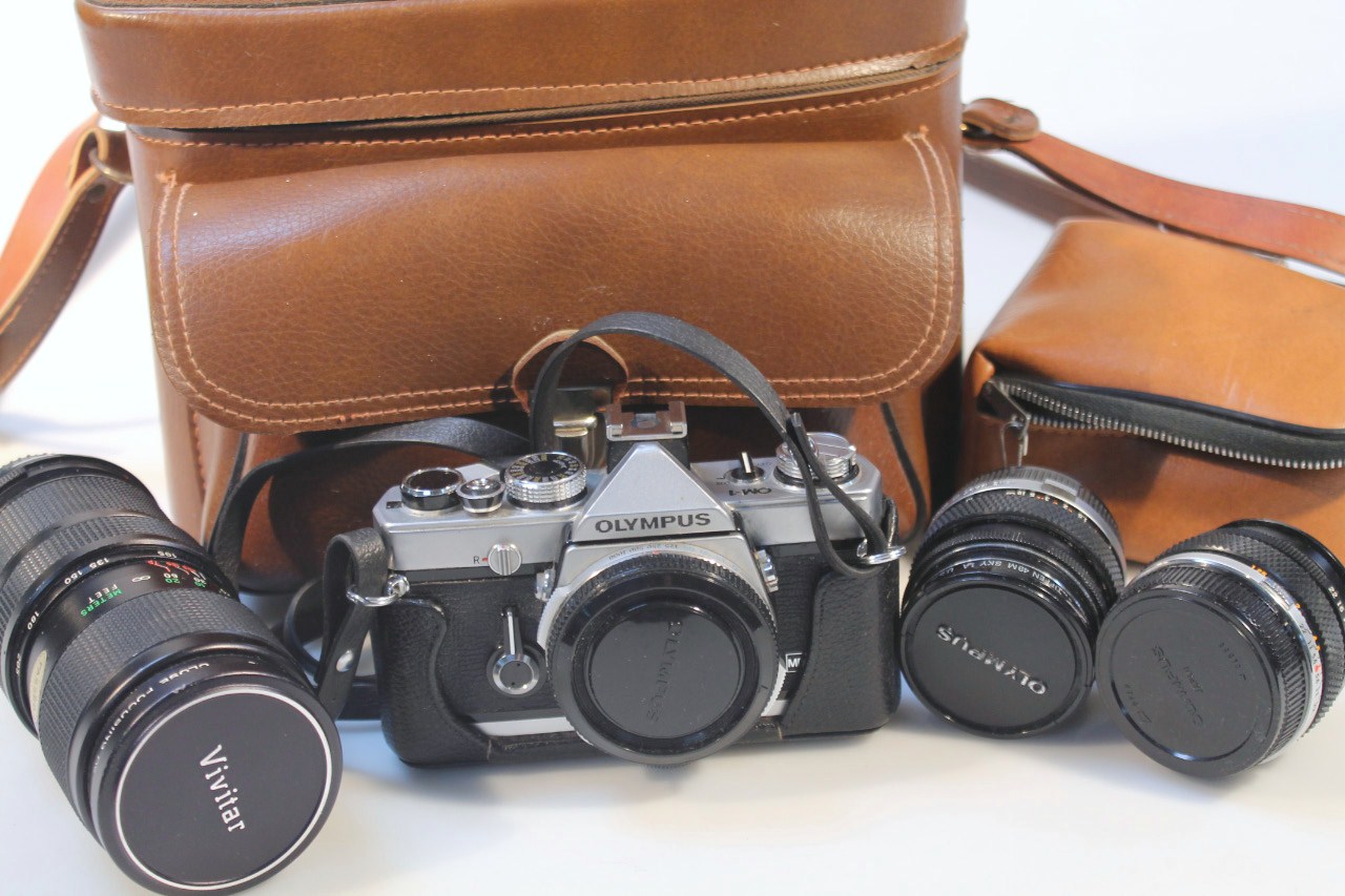 An Olympus OM1 single lens reflex camera, with Olympus Zuiko 50mm lens, Olympus Zuiko 28mm lens,