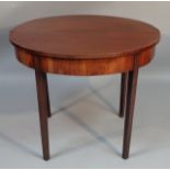 A 19thC mahogany fold over tea table, the D-end top with a plain outline raised on square tapering
