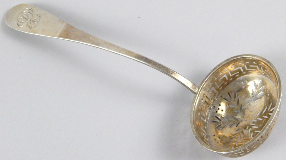 A 19thC sifter spoon, marked F Gely, Old English pattern, with an oval part pierced bowl, white