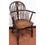 A 19thC Nottinghamshire yew wood and elm low back Windsor chair, with a hoop back centred by a
