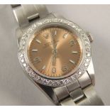 A Rolex Oyster Perpetual ladies wristwatch, with pink dial and diamond encrusted surround, stainless