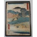A Hiroshige ink block print, of villagers crossing a swollen river, picked out in colours, signed,