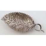 A 19thC caddy spoon, the leaf petal bowl set with a ring end, Continental white metal, 7.5cm wide.