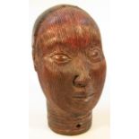 A Benin tribal terracotta head, heavily carved to the front with a part pierced back and neck,