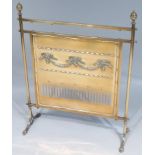 An Edwardian brass fire screen, surmounted by two urn finials with a plain bar top above a