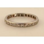 A ladies white metal eternity ring, set with small diamonds, 3.2g, size Q. (AF)