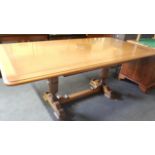 A mid-20thC oak refectory table, the plank top with a moulded edge, on cup and cover supports,