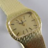 A 14K Rolex ladies dress watch, with solid articulated strap, with oblong dial.
