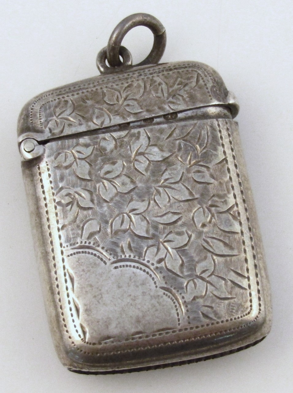 A late Victorian silver vesta case, by John Gammage, the oblong body part decorated with floral