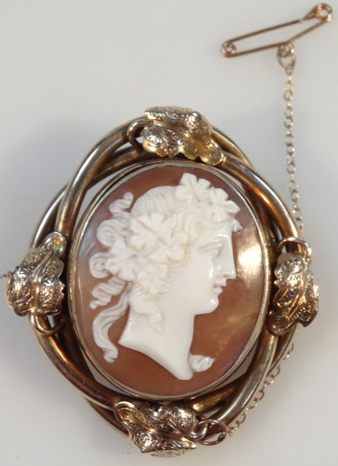 An early 20thC Italian shell cameo, formed as a lady side profile, in an entwined setting set with