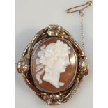 An early 20thC Italian shell cameo, formed as a lady side profile, in an entwined setting set with