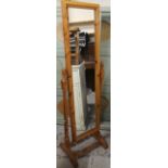 A modern stripped and polished pine cheval mirror, the rectangular outline centred by a plain