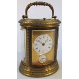 A 19thC French oval engraved brass carriage clock, with striking mechanism, repeat action and alarm,