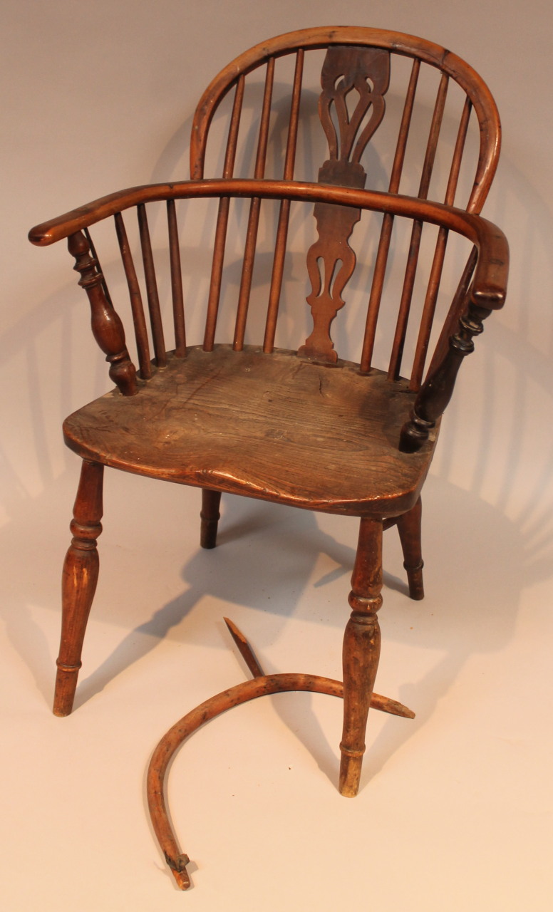 A 19thC yew and elm low back Windsor chair, with a pierced back splat, 'C' scroll arm supports and