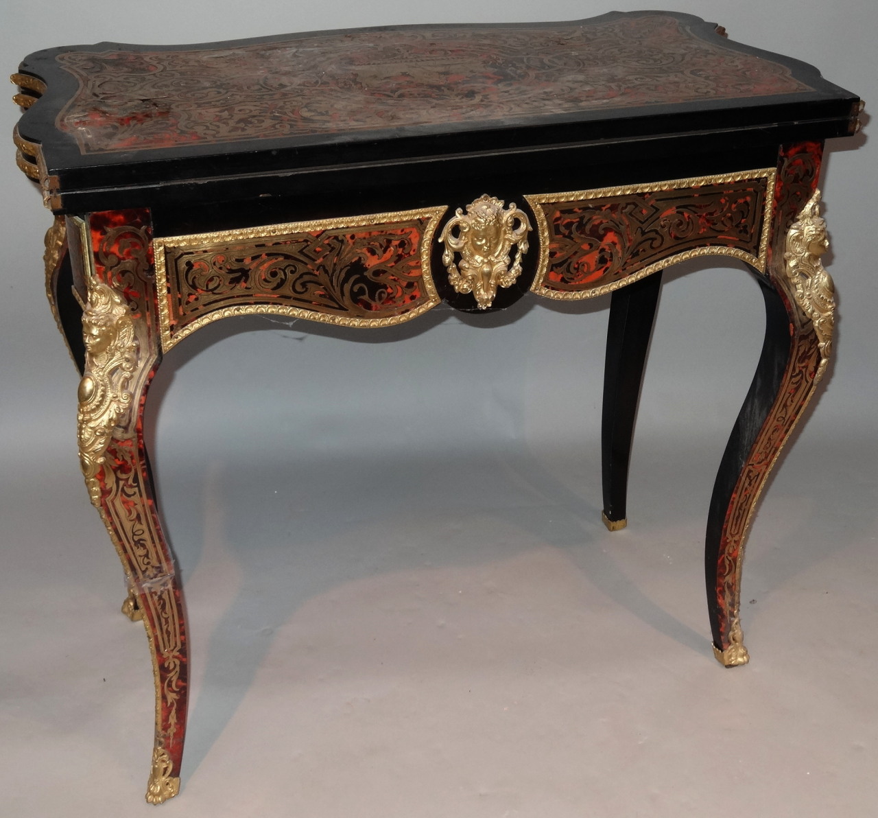 A 19thC French Boulle ebonised and ormolu games table, with serpentine outline the top fronted by - Image 3 of 5