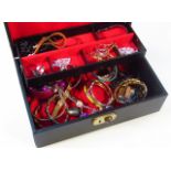 Various costume jewellery, to include bangles, dress rings, etc, contained in a leather finish