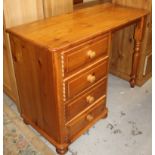 A modern stripped and lightly polished pine single desk, the oblong overhanging top raised above