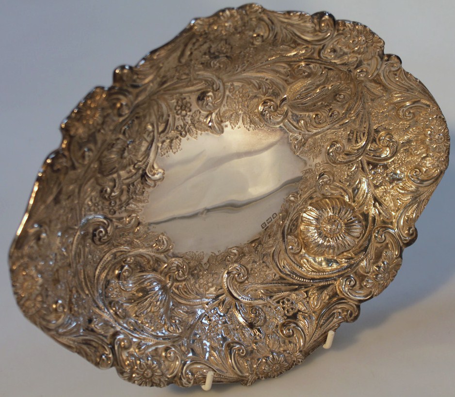 A Victorian silver bon bon basket, by Charles Stuart Harris, the lozenge shaped body repoussé