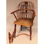 A 19thC yew wood and elm Windsor chair, with a pierced back splat 'C' scroll arm supports and shaped