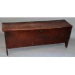 A 17thC elm sword chest, the hinged lid with naive carved sides, hinging to reveal a plain