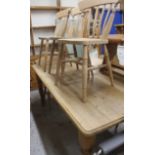 A large 20thC stripped and lightly polished pine kitchen table, the oblong top raised on carved