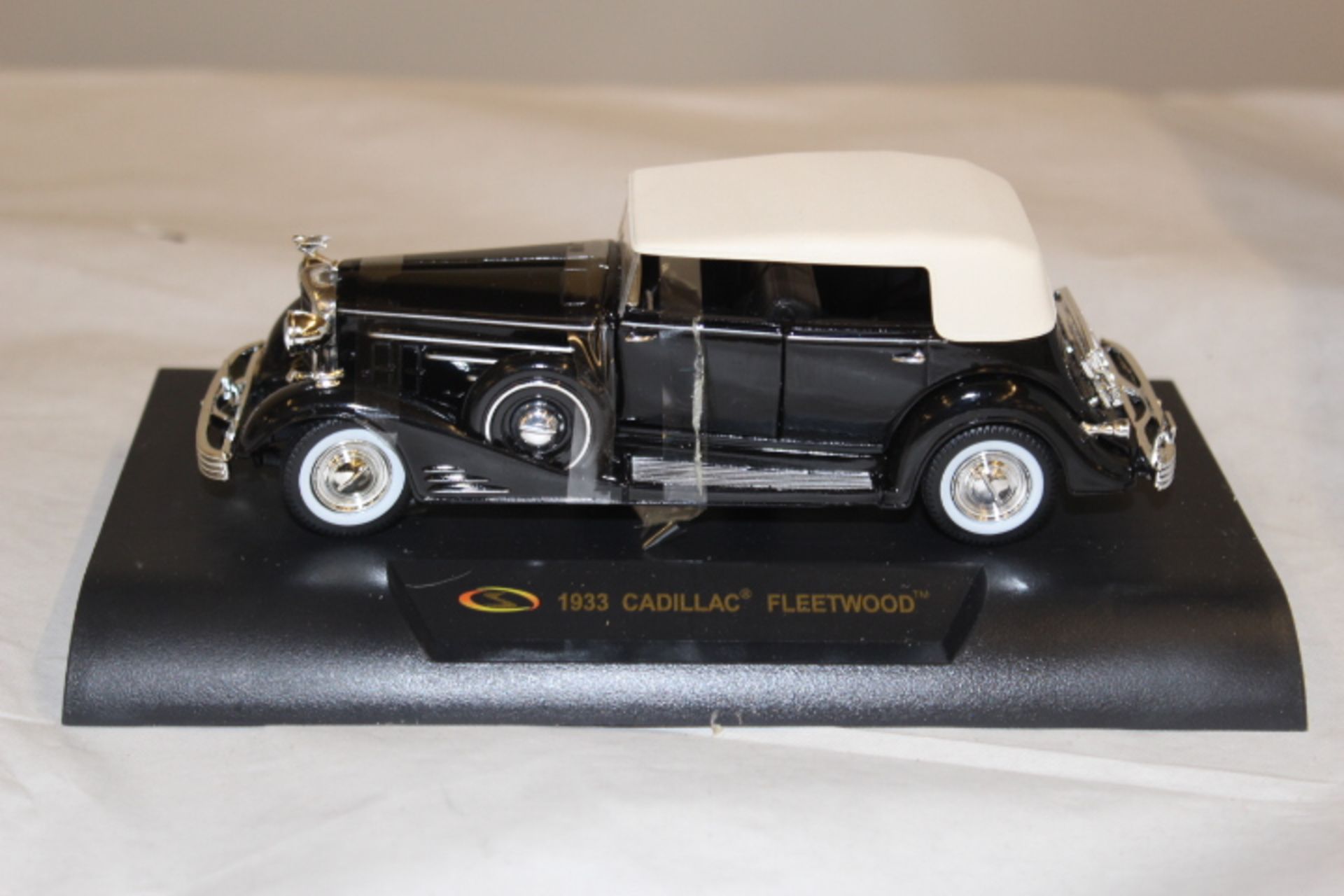 Die cast 1933 Caddillac Fleetwood model vehicle on stand