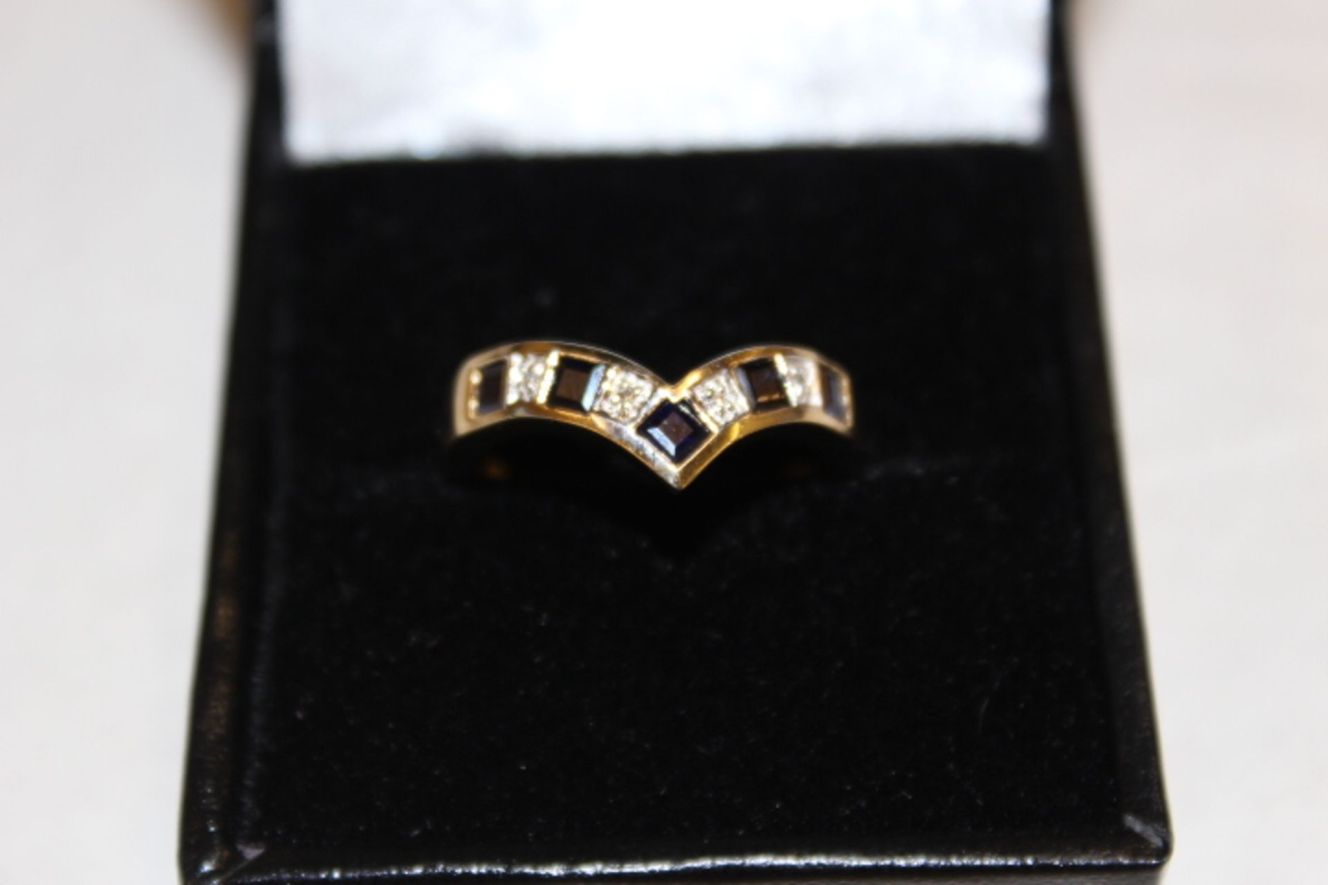 Ladies Gold Ring Set with Five sapphires and diamonds in a wishbone style