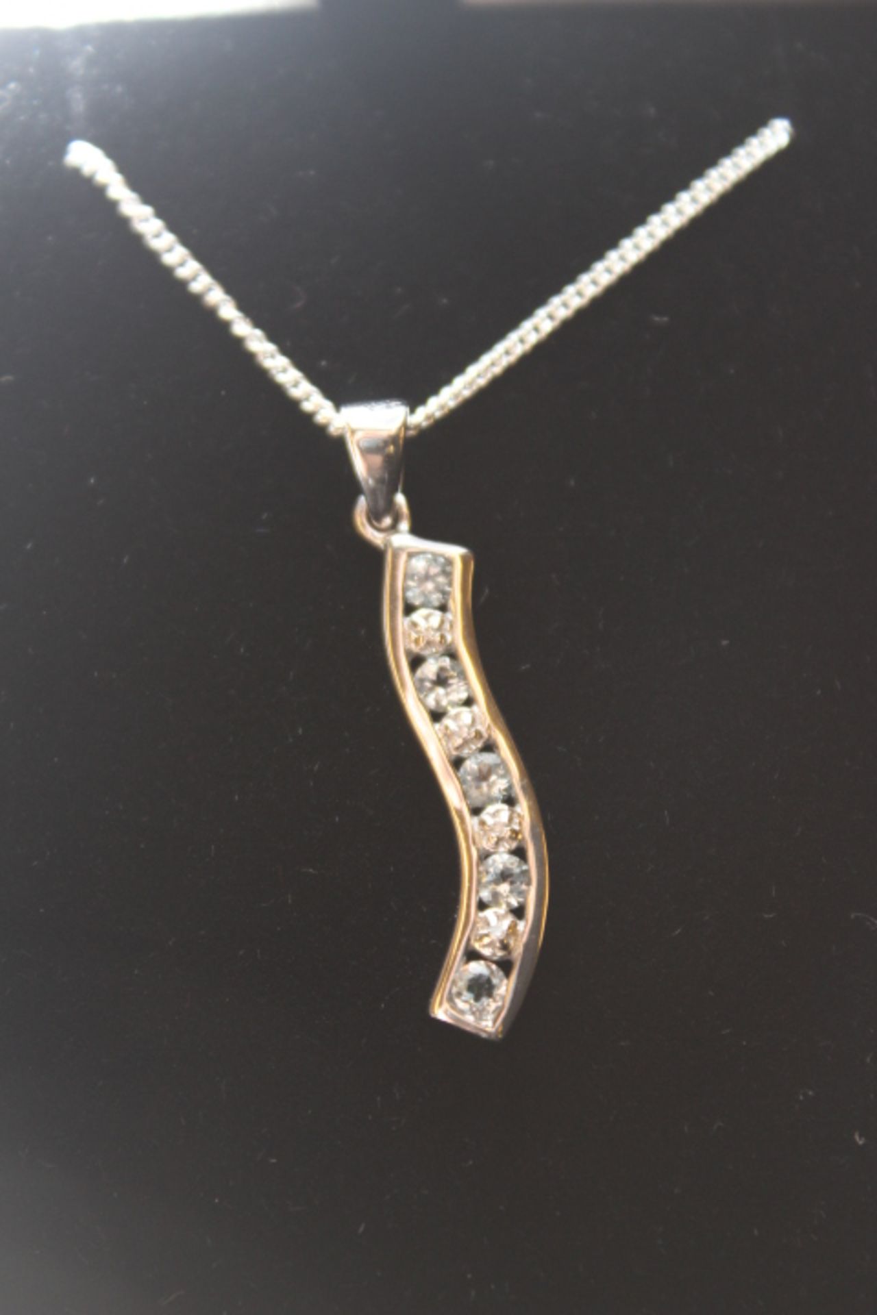 Wm diamond and aquamarine wavey style pendant and chain