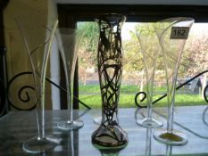 A Filigree Vase and five elegant champagne flutes