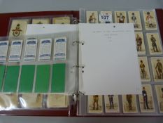 A cased set of cigarette cards and silks