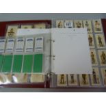 A cased set of cigarette cards and silks