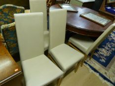 A set of four cream leather dining chairs