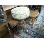 A Victorian revolving piano stool