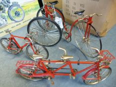 Four scale models of various bicycles