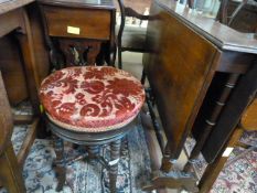 A victorian revolving piano stool