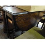 A drop leaf table on barley twist legs